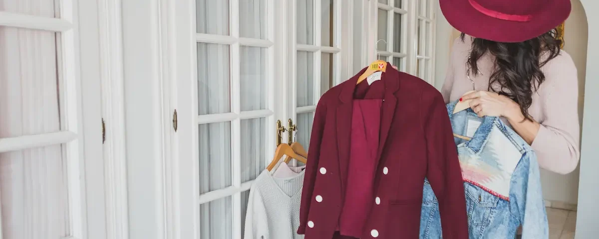 Stylish young woman looking at a burgundy suit